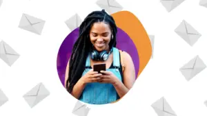 A girl happily sending SMS through phone.